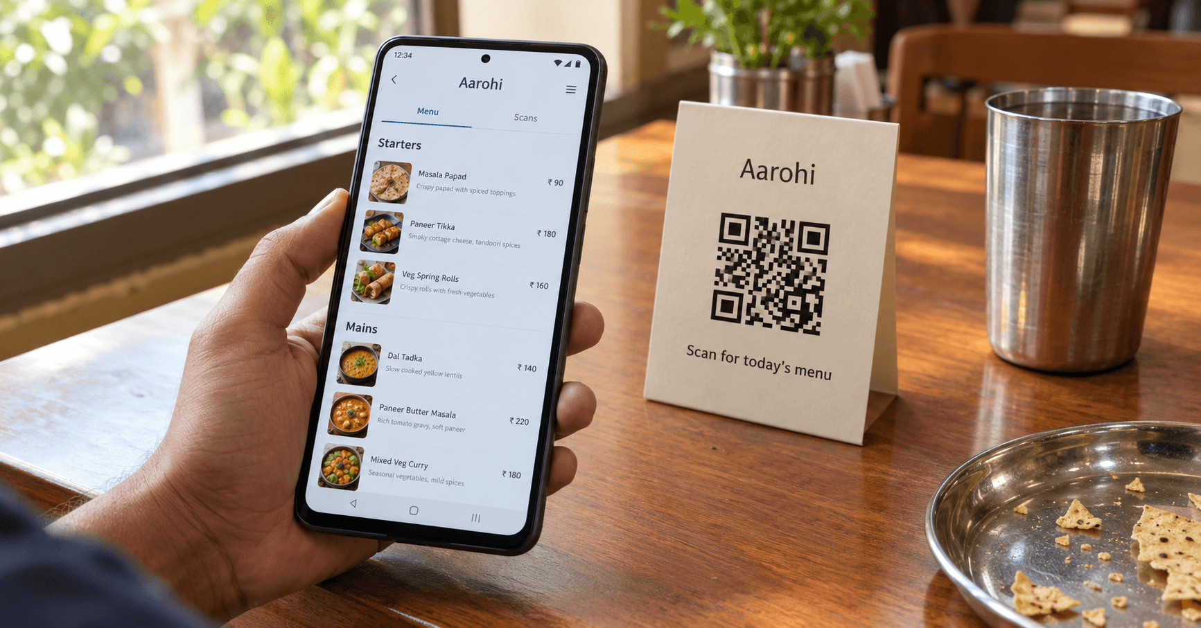 Restaurant table tent with a QR code menu being scanned, digital menu open on a smartphone