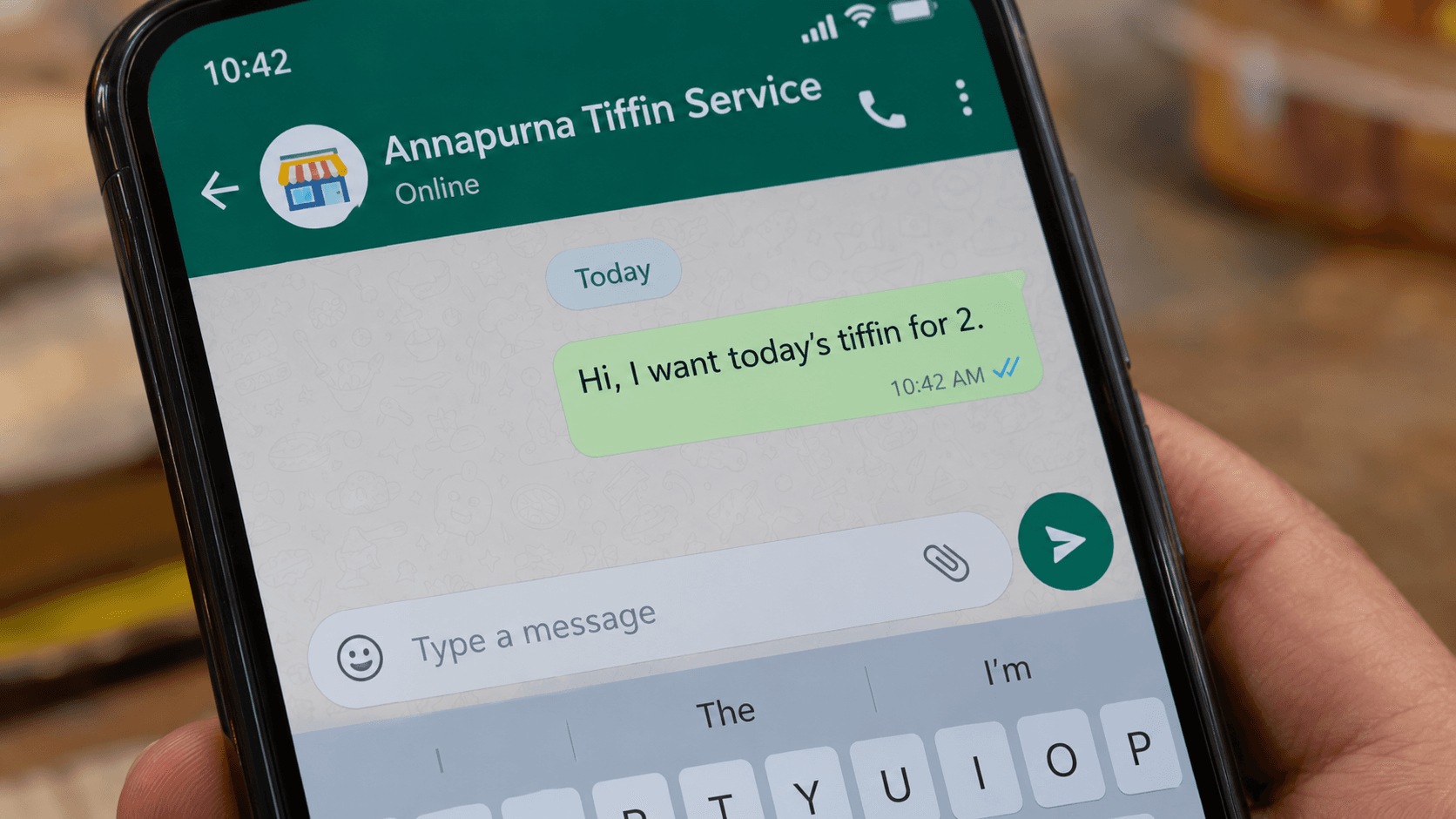 Smartphone showing a WhatsApp chat opened from a QR code with a pre-filled business message