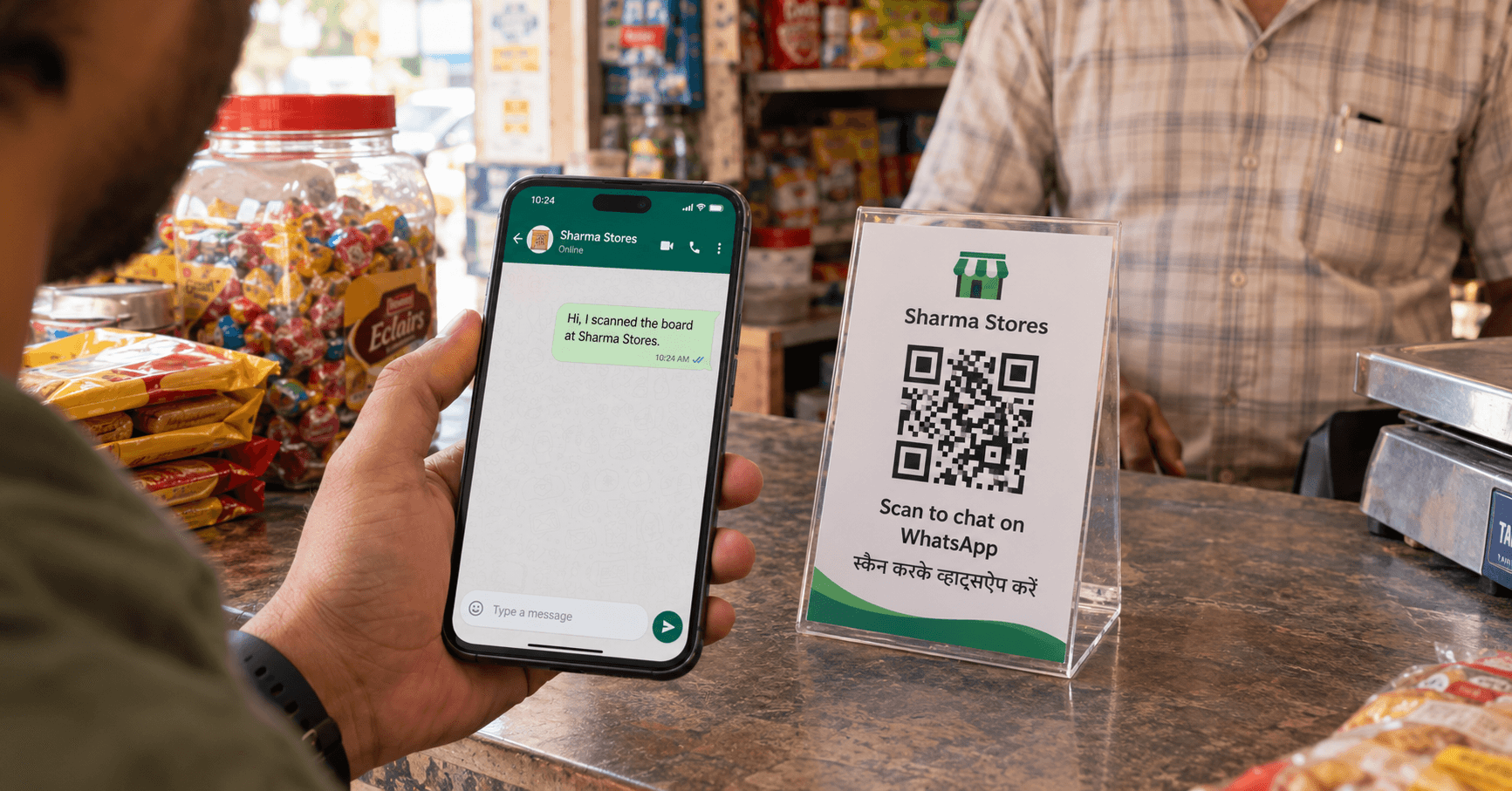WhatsApp QR code on a shop standee opening a business chat on a smartphone